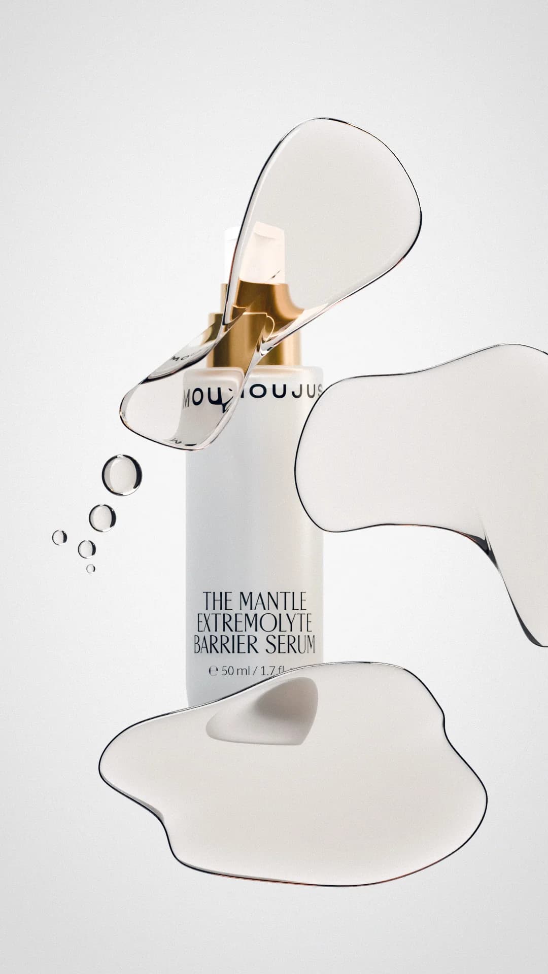The Mantle bottle surrounded by floating drops of clear liquid
